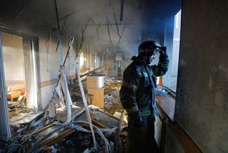 A firefighter works inside a building of a children's hospital, damaged by recent shelling that local Russian-installed authorities called a Ukrainian military strike, while the hospital was under maintenance with no patients inside, in the course of the Russia-Ukraine military conflict in Donetsk, a Russian-controlled city of Ukraine